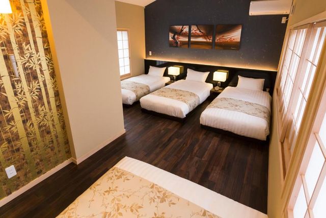 Bed room with 3 single beds and 1 double bed.