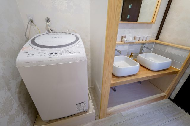 Wash machine is beside the wash basin. You can wash your clothing and  towel like you are staying home. Detergent ball for washing machine is prepared.