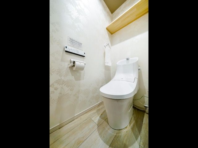 Wash room has Japanese bidet attachments.
