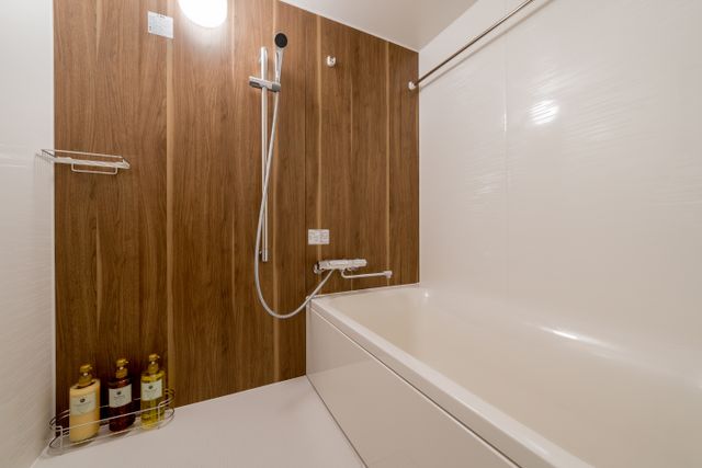 The room has a private bathroom. The toilet is separate. The bathroom has a sink with hand towels and soap and other amenities. The bathroom has a small bathtub and shower.