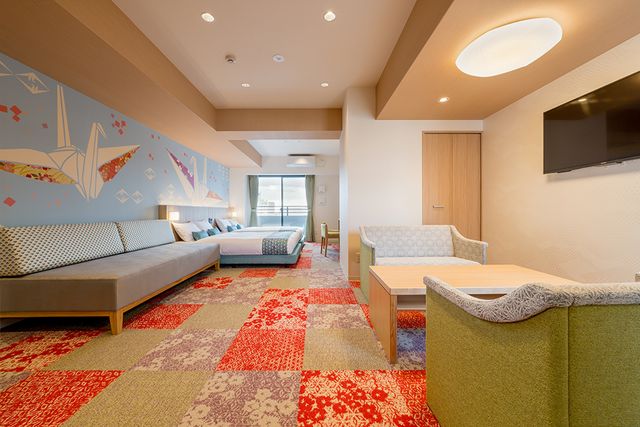Welcome to THE Nishijin ! This room has two Double beds and a sofa bed. This room has playful "ORIGAMI" decorations on the wall.