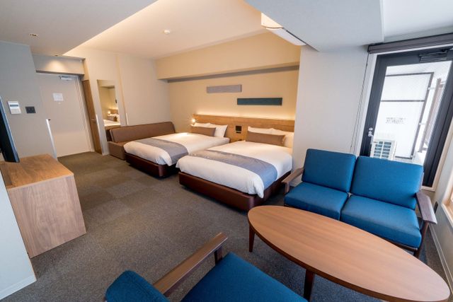 This room has two double beds and Sofa bed.